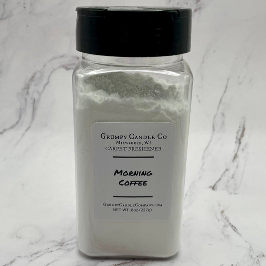 Jar of 'Morning Coffee' carpet freshener by Grumpy Candle Co on a marble surface